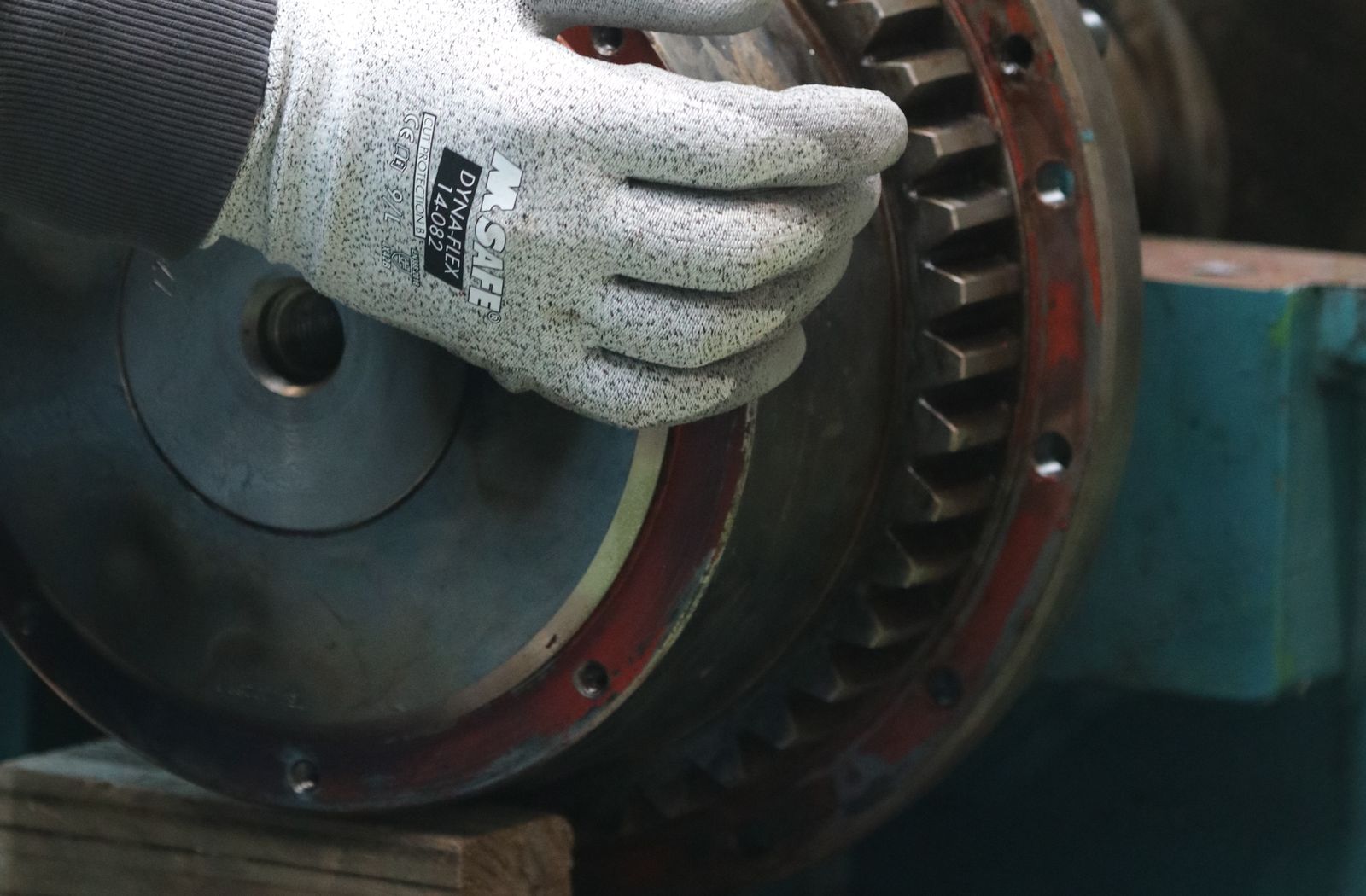Technician reassembling a rebuilt industrial gear assembly with quality parts and controlled workmanship.